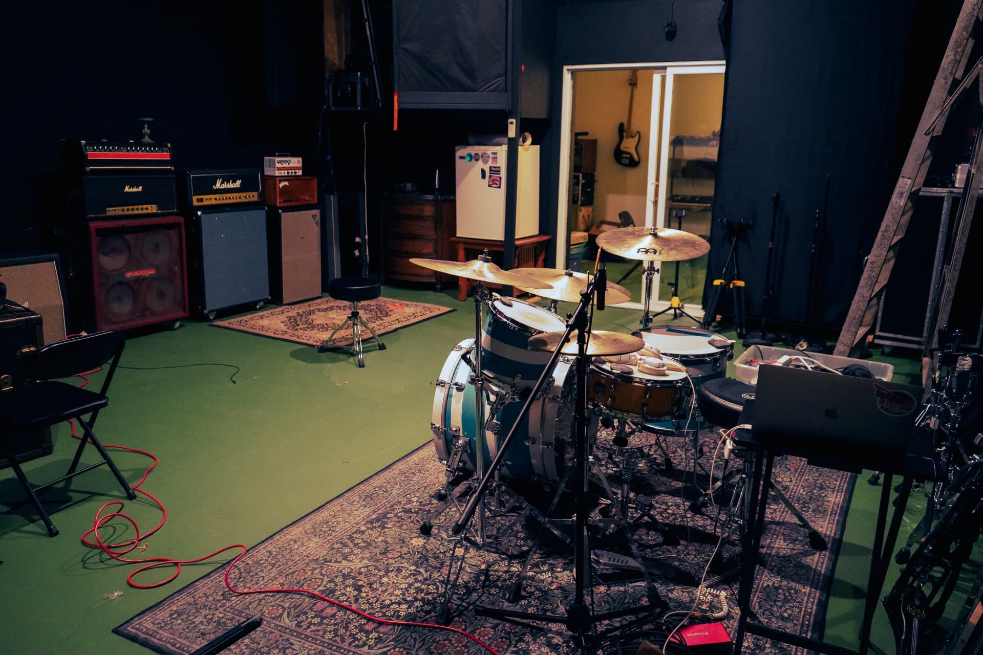 Drum kit and amplifiers in the live room at The Meadow